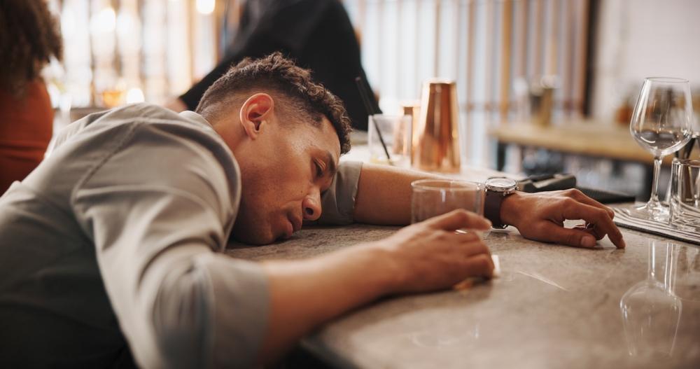 A man who is unconscious and unable to legally consent after drinking.