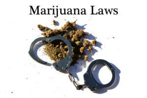 A pair of handcuffs sitting over a pile of marijuana, symbolizing the key changes to Ohio Senate Bill 56 for marijuana and hemp laws